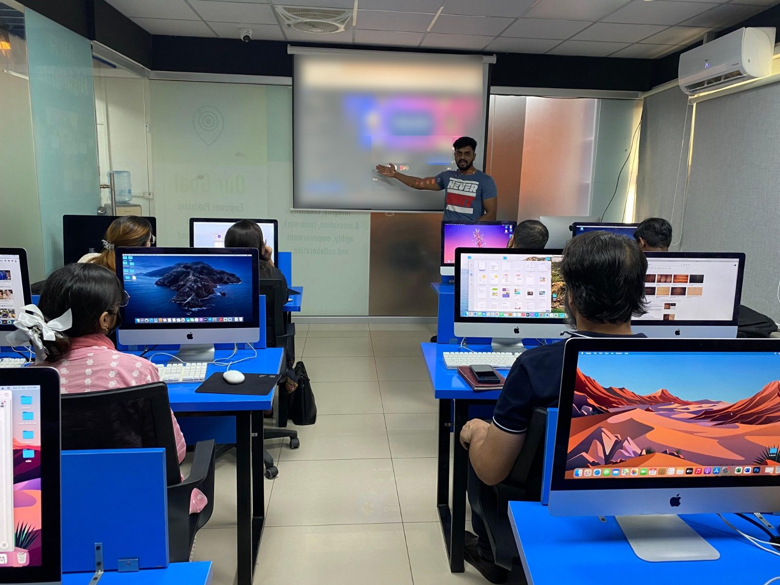 A BBT instructor teaching a class at the Lahore campus